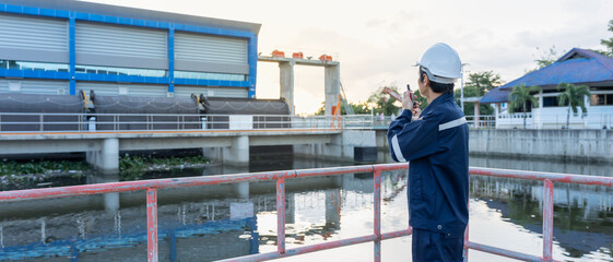 Naklejka premium maintenance and inspector. Maintenance engineers are using walky talky to inform the results of inspection of buildings and structures. Irrigation engineers are exploring sluice systems