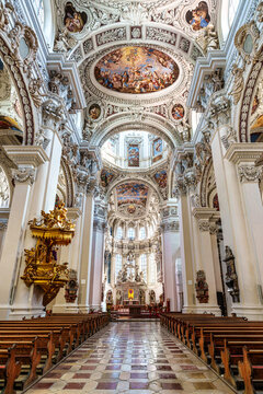 Interior of St. Stephans cathedral in Passau, Germany is an old white church with famous organ pipes