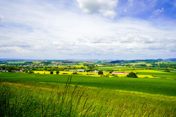 Obraz premium View of the green landscape with fields and meadows near Felsberg. 