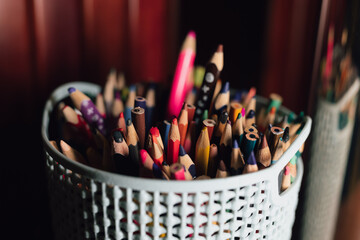 Many multi-colored pencils in a basket