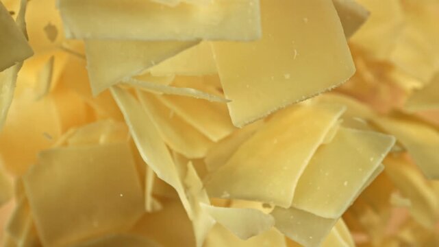 Super slow motion Parmesan cheese on a light background. Filmed on a high-speed camera at 1000 fps. High quality FullHD footage
