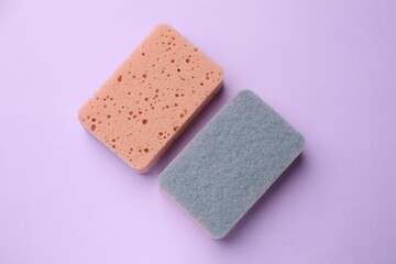 Kitchen sponges on violet background, flat lay
