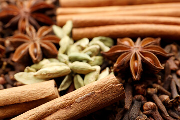Mulled wine spices. Anise stars, cinnamon sticks, cardamon seeds and cloves as background, closeup