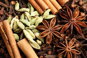 Mulled wine spices. Anise stars, cinnamon sticks, cardamon seeds and cloves as background, top view
