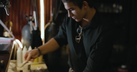 A bartender at work behind the bar, making cocktails