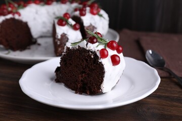 Tasty Christmas cake with cranberries and rosemary on wooden table, closeup
