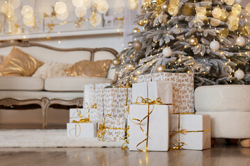 Gift boxes near Christmas tree on floor indoors