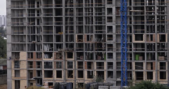 Close Up Video of Construction Crane Lowering Concrete Bucket on Highrise Building
