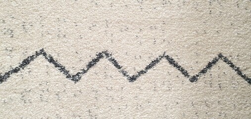 The texture of a white carpet with a pattern of simple black broken and intersecting lines. Carpets for home decor, wallpaper, textiles, and fashion.