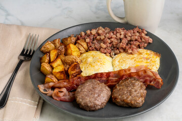eggs over easy with corn beef hash and home fries