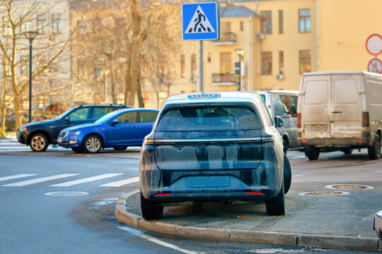 Fototapeta Car parked illegally on sidewalk near pedestrian crossing creating serious visibility hazard for drivers and pedestrians, traffic risks, potential fines or towing consequences. Improperly parked SUV