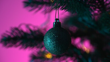 Sparkling Christmas Ornament on Pine Tree with Pink Background