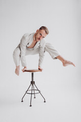 man dancing on the chair. New trending colour of the 2026 year 