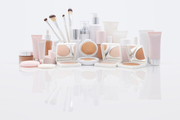 Collection of Makeup and Beauty Products on a glossy reflective background