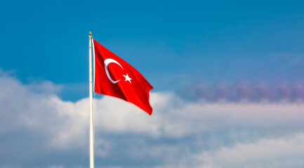 Turkish national flag waving against partly cloudy sky—captured in symbolic composition highlighting cultural identity, open air atmosphere, and patriotic presence.