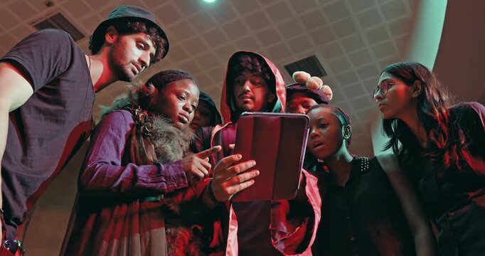 Indian young adult gen z male man lady female talk speak use tab look screen do online e learning study check work. Happy boy girl group spend break time enjoy have fun joy new day stage hall place