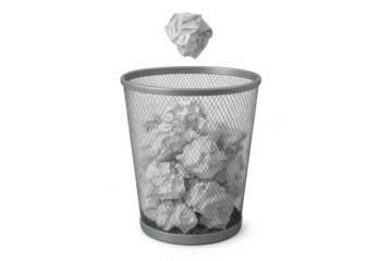 Crumpled paper falling into a metal trash bin, representing mistakes, failure, and creative struggles on a transparent background