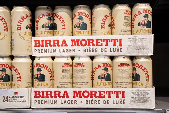 Close up of Birra Moretti Autentica lager cans stacked on store shelf. Toronto, Canada - December 3, 2025.