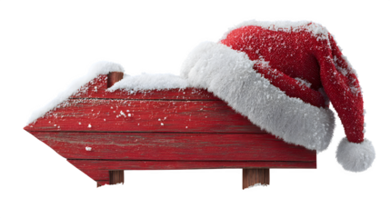 Red wooden arrow signboard decorated with snow and Santa hat isolated on white background