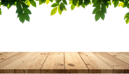 Empty wooden table top with green leaves in the foreground isolated on a white background