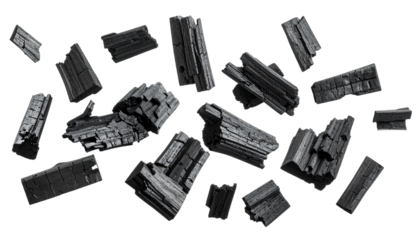 A diverse collection of dark crystalline rock shards, raw minerals, and natural geological samples spread on a pure white backdrop