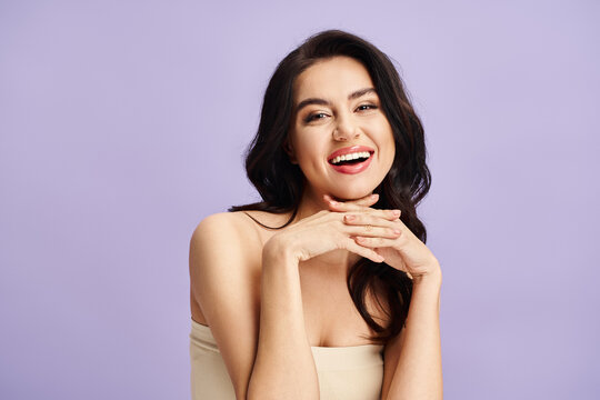 Young beautiful woman sharing a radiant smile against a lovely pastel backdrop
