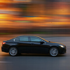 Obraz premium Black car driving fast with motion blur background AI generated
