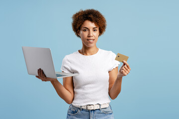 Woman shopping online, holding laptop and credit card for secure e commerce payment