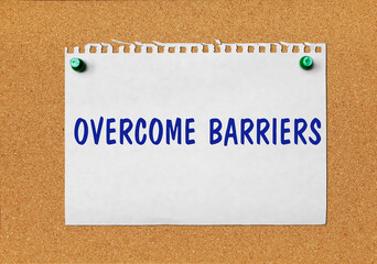 An advertisement &laquo;Overcome barriers&raquo; on a piece of paper attached to a notice board