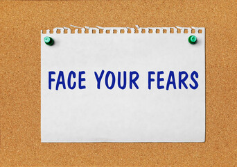 An advertisement &laquo;Face your fears&raquo; on a piece of paper attached to a notice board