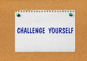 An advertisement &laquo;Challenge yourself&raquo; on a piece of paper attached to a notice board