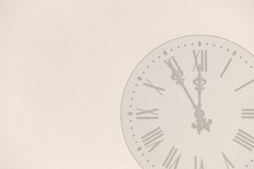 A faint image of a clock face on paper