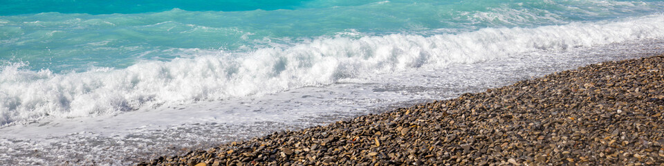 Deserted rocky pebble beach. Abstract nature pebbles background. Pebbles texture. Stone beach. Horizontal banner
