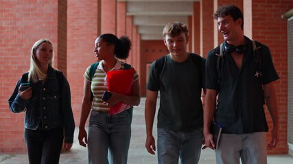 Diverse group of students walking in university corridor