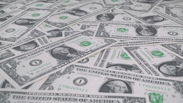 Close-up Of One Dollar Bills Lying Around Haphazardly.