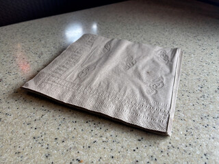 Napkins on a Restaurant Counter with Neutral Tile
