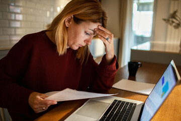 Adult woman stressed about bills at home