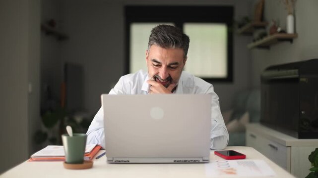 Successful businessman finishing work and relaxing at home office