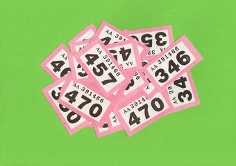 A montage of vintage raffle tickets on a bright green background with space for copy or text.