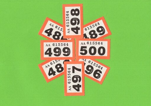 A montage of vintage raffle tickets on a bright green background with space for copy or text.