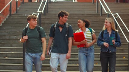 Group of diverse college students walking together on campus stairs - Powered by Adobe
