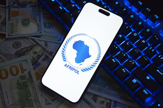 The smartphone with Interpol logo displayed on screen. International Criminal Police Organization or Interpol.