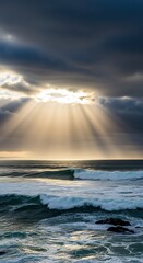 Obraz premium Dramatic Ocean Scene - Sun Rays Piercing Through Stormy Clouds.