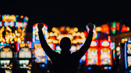Silhouette man raising arms winner casino lights background copy space success victory jackpot gambling concept happy celebration emotion lucky player betting win dark atmosphere banner promotion
