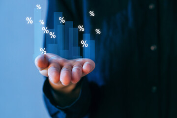 Man holding hand with digital bar graph and percentage symbols showing growth in financial data