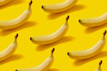 Vibrant Yellow Banana Pattern with Hard Shadows on Bright Background