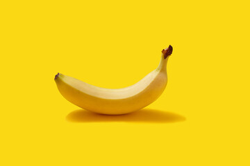 Fresh Ripe Banana on Solid Yellow Studio Background