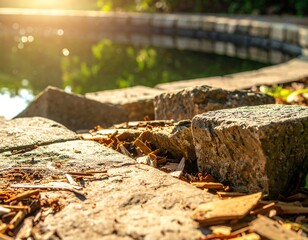 Fototapeta premium Close-up of weathered stone blocks bordering a tranquil pond in sunshine