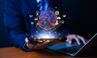 A businessman uses a digital tablet displaying a glowing global network with data icons, symbolizing innovation, analytics, and modern technology for business growth in the digital era.
