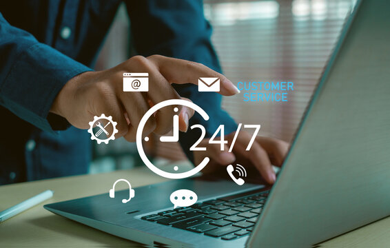Hand using laptop with virtual 24-7 customer service icons, representing online support system, email and call center communication, digital help desk and modern business service technology.